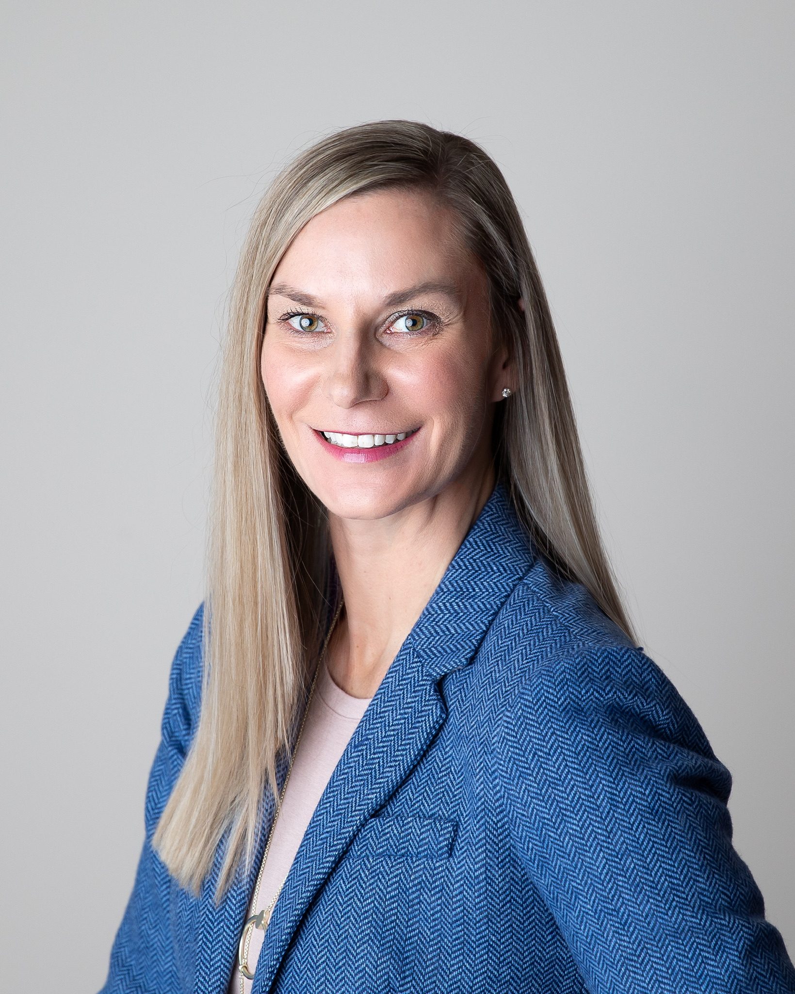 Dr. Melissa Loseke Ablett smiling, wearing a blue jacket.